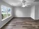 Spacious living room featuring a ceiling fan, luxury vinyl plank flooring and neutral paint at 1325 Crandon Dr, Charlotte, NC 28216