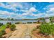 Lush backyard featuring well-maintained landscaping and serene water views on a sunny day at 139 Little Indian Loop, Mooresville, NC 28117