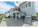 Backyard of this beautiful home offers a covered porch, stone patio, second story deck and an outdoor stairwell at 139 Little Indian Loop, Mooresville, NC 28117