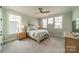 Charming bedroom filled with natural light features neutral paint, carpet, ceiling fan, and a bed in front of three windows at 139 Little Indian Loop, Mooresville, NC 28117