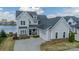 Beautiful gray two-story home featuring an attached two-car garage and well-manicured landscaping at 139 Little Indian Loop, Mooresville, NC 28117