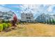 Well-manicured lawn and landscaping complement this beautiful home with dual-level balconies and plentiful natural light at 139 Little Indian Loop, Mooresville, NC 28117