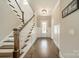 Inviting foyer featuring hardwood floors, elegant staircase, and a stylish front door at 139 Little Indian Loop, Mooresville, NC 28117