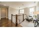 Open hallway with wood floors, bright natural light, and an accent chair at 139 Little Indian Loop, Mooresville, NC 28117