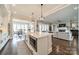 Open concept kitchen featuring a kitchen island, stainless appliances, and a view into the living and dining rooms at 139 Little Indian Loop, Mooresville, NC 28117