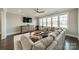Bright living room with a corner sectional sofa and large windows overlooking a lake at 139 Little Indian Loop, Mooresville, NC 28117