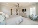 Comfortable main bedroom featuring soft carpet, soft colors, a TV, and a sitting chair for ultimate relaxation at 139 Little Indian Loop, Mooresville, NC 28117