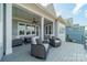 Charming porch with gray furniture, white columns, plank ceiling, and ceiling fan offers a relaxing place to gather outdoors at 139 Little Indian Loop, Mooresville, NC 28117
