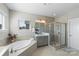 Bright bathroom featuring a large soaking tub and a separate walk-in shower at 1519 Cedar Park Dr, Pineville, NC 28134