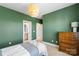Inviting bedroom with green accent walls, a comfortable bed, tasteful decor, and an ensuite bathroom at 1519 Cedar Park Dr, Pineville, NC 28134