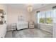 Cozy Bedroom with a white crib, comfortable armchair, and lots of natural light at 1519 Cedar Park Dr, Pineville, NC 28134