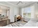 Bright bedroom features a ceiling fan, natural light, and a cozy desk area with elegant white trim and neutral tones at 1519 Cedar Park Dr, Pineville, NC 28134