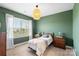 Unique bedroom with green accent walls, soft carpet, window treatments, a comfortable bed, and tasteful decor at 1519 Cedar Park Dr, Pineville, NC 28134