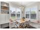 Bright breakfast nook with built-in seating, large windows, and chandelier lighting at 1519 Cedar Park Dr, Pineville, NC 28134