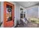 Inviting front porch with seating area, potted plants, and a colorful front door at 1519 Cedar Park Dr, Pineville, NC 28134