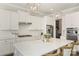 Elegant white kitchen with stainless steel appliances and center island with seating at 1519 Cedar Park Dr, Pineville, NC 28134