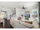 Open-concept living room and staircase with large sectional sofa and built-in shelving at 1519 Cedar Park Dr, Pineville, NC 28134