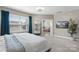 Bright main bedroom features an ensuite bathroom, soft carpet, window treatments, a comfortable bed, and tasteful decor at 1519 Cedar Park Dr, Pineville, NC 28134