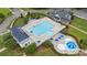 Aerial view of a community pool and kiddie pool with umbrellas and lounge chairs at 1519 Cedar Park Dr, Pineville, NC 28134