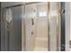 Modern walk-in shower with neutral tile, a built-in bench, and a glass enclosure at 1519 Cedar Park Dr, Pineville, NC 28134