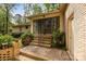 Back patio with brick steps, a screened-in porch, and lush greenery at 1676 Partridge Cir, Lancaster, SC 29720