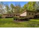 Backyard featuring a brick exterior, green lawn, and mature trees at 1676 Partridge Cir, Lancaster, SC 29720