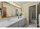 Bright bathroom featuring a long vanity with a white countertop, a large mirror, and modern fixtures at 1676 Partridge Cir, Lancaster, SC 29720
