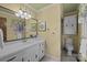 Bathroom featuring a double vanity, decorative mirror, and window with natural light at 1676 Partridge Cir, Lancaster, SC 29720