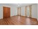 Spacious bedroom with hardwood floors, natural light, and decorative curtains at 1676 Partridge Cir, Lancaster, SC 29720