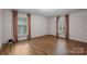 Bright bedroom with hardwood floors and two windows, offering ample natural light at 1676 Partridge Cir, Lancaster, SC 29720