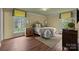 Cozy bedroom with hardwood floors, a comfortable bed, and ample natural light from two windows at 1676 Partridge Cir, Lancaster, SC 29720