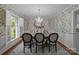 Elegant dining room with floral wallpaper, a chandelier, and a large table with seating for six at 1676 Partridge Cir, Lancaster, SC 29720