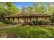 Traditional brick home with shutters, a well-maintained lawn, and mature landscaping for curb appeal at 1676 Partridge Cir, Lancaster, SC 29720