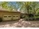 Brick home features a multi-car garage and a spacious driveway surrounded by lush trees at 1676 Partridge Cir, Lancaster, SC 29720