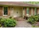 Home's inviting brick front entrance features double doors, shutters and brick steps at 1676 Partridge Cir, Lancaster, SC 29720
