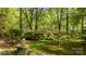 Attractive single-story home nestled among mature trees and lush greenery at 1676 Partridge Cir, Lancaster, SC 29720