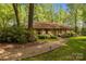 Charming home featuring a brick facade, shutters, and a well-manicured front yard at 1676 Partridge Cir, Lancaster, SC 29720