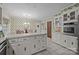 Eat-in kitchen featuring white cabinets, tile counters and floors, and decorative wallpaper at 1676 Partridge Cir, Lancaster, SC 29720