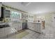 Charming kitchen with white cabinets, tile countertops, and a bright, airy feel, perfect for home cooking at 1676 Partridge Cir, Lancaster, SC 29720