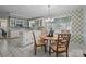 Charming kitchen with white cabinetry, tiled countertops, and a cozy breakfast nook with a view at 1676 Partridge Cir, Lancaster, SC 29720