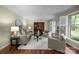 Comfortable living room with large windows, neutral decor, and a cozy seating area, ideal for gatherings at 1676 Partridge Cir, Lancaster, SC 29720