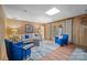 Spacious living room with hardwood floors, wood paneling, and comfortable seating, creating a cozy and inviting space at 1676 Partridge Cir, Lancaster, SC 29720