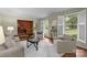 Bright living room features large windows, hardwood floors, and comfortable seating, creating a welcoming space at 1676 Partridge Cir, Lancaster, SC 29720