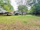 Expansive backyard with mature trees and carport at 1780 Short St, Mount Pleasant, NC 28124