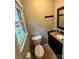 Small half-bath with a toilet, sink, and a window at 1780 Short St, Mount Pleasant, NC 28124