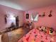 Bright bedroom featuring pink walls, a vibrant rug, and a charming princess-themed bedding set at 1780 Short St, Mount Pleasant, NC 28124