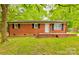 Charming brick home featuring a welcoming front porch and a classic, clean design at 1780 Short St, Mount Pleasant, NC 28124