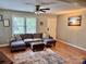 Comfortable living room with a plush sectional sofa, ceiling fan, and ample natural light at 1780 Short St, Mount Pleasant, NC 28124