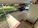 Backyard patio, with partial covering, a grill, and a view of the backyard at 1780 Short St, Mount Pleasant, NC 28124