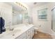 Bathroom with a double sink vanity, large mirror, and a glass-enclosed shower at 1801 Briarcrest Nw Dr, Charlotte, NC 28269